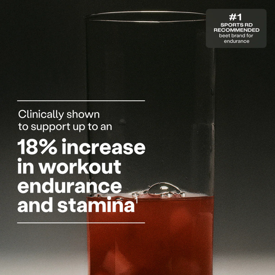 Glass of red liquid with text about workout endurance and stamina on a dark background
